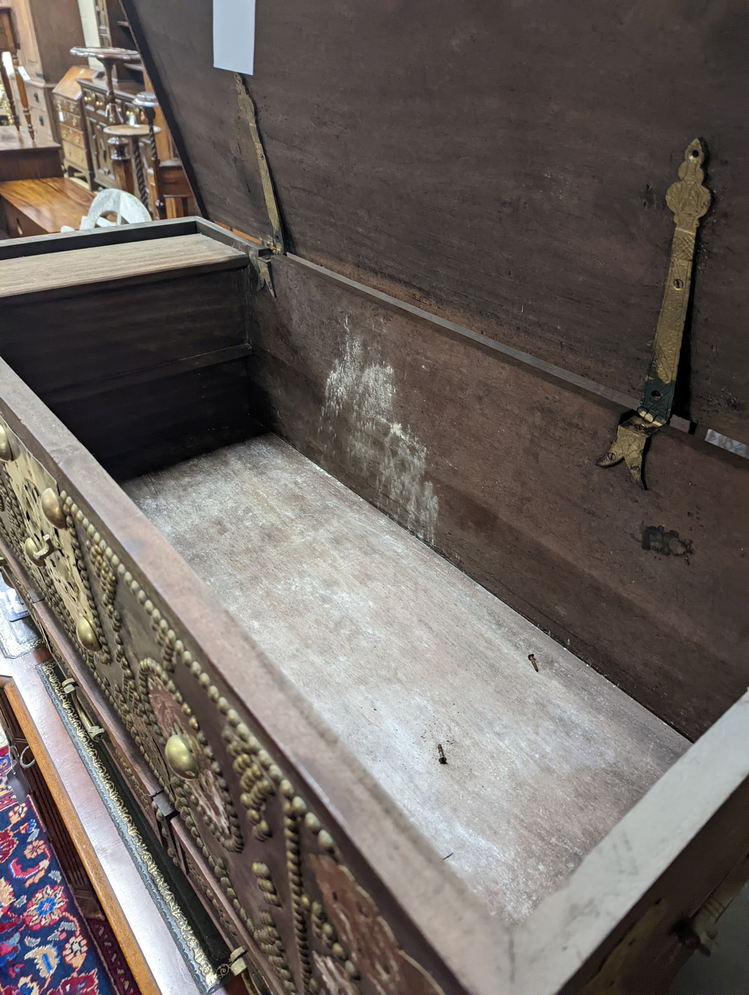 An Eastern brass mounted and studded hardwood trunk, length 113cm, depth 48cm, height 60cm